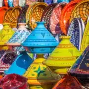 Colorful Moroccan pottery displayed for sale at a vibrant market, showcasing the rich local lifestyle and craftsmanship.