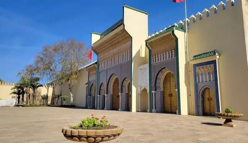 Courtyard of the Sultan's Palace in Morocco, showcasing intricate architecture and lush greenery, a highlight for visitors.