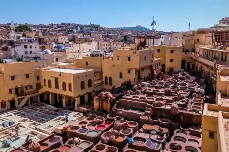 Colorful pots and pans displayed in a bustling Moroccan market, showcasing the vibrant culture and craftsmanship of Morocco.