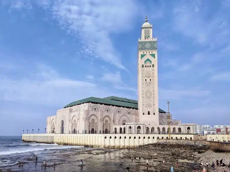 A mosque on the beach, overlooking the ocean, showcasing a unique things to do in Casablanca.