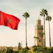 Morocco flag waving in front of the Moroccan palace, showcasing national pride against a historic architectural backdrop.