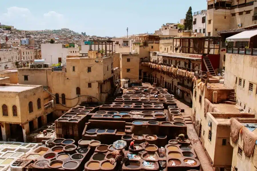 A vibrant market scene in Morocco showcasing an array of colorful pots and pans for sale.