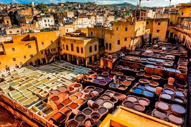 A vibrant Moroccan city scene showcasing numerous colorful pots and barrels, highlighting its rich cultural heritage.