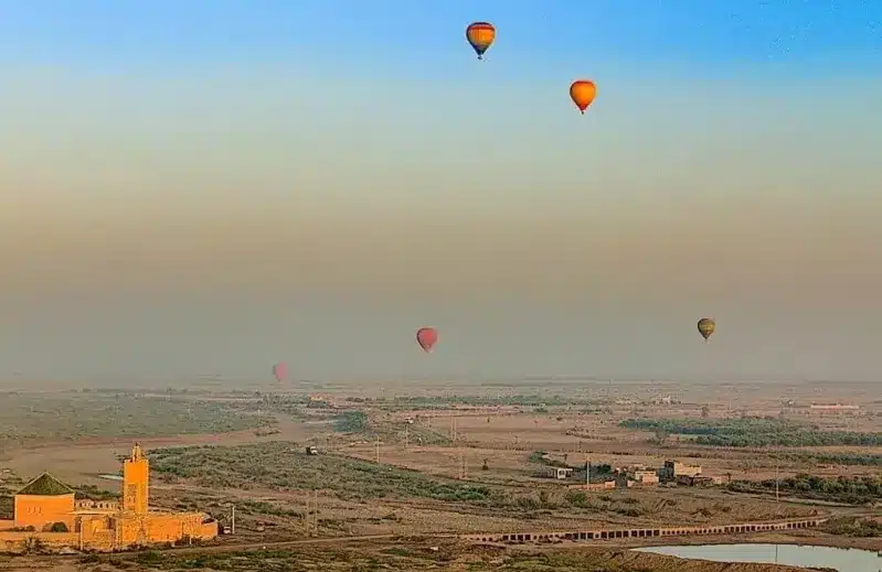 Hot air balloons soaring over a vast desert landscape, promoting Moroccan Airlines USA.