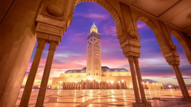 A mosque illuminated by sunset, showcasing its architectural beauty, representing one of the best cities to visit in Morocco.