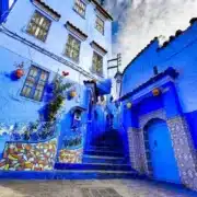 Scenic view of Chefchaouen, Morocco, known for its blue buildings and stunning mountain backdrop, a top travel destination.