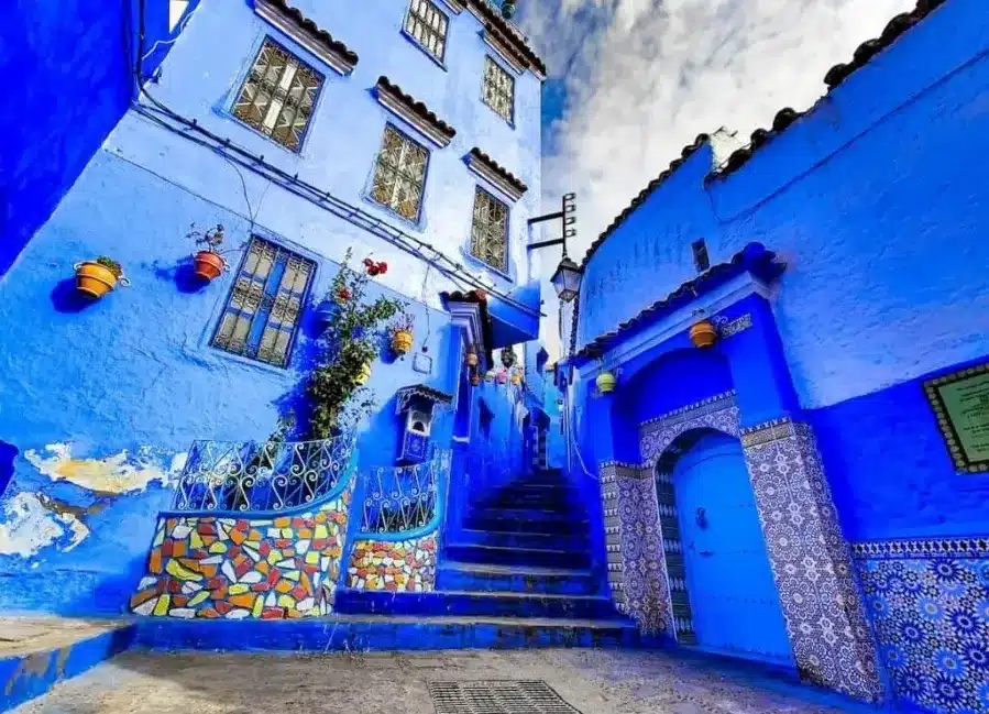 Scenic view of Chefchaouen, Morocco, known for its blue buildings and stunning mountain backdrop, a top travel destination.