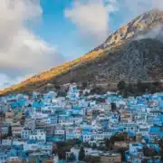 Scenic view of Chefchaouen, Morocco, known for its blue-washed buildings and stunning mountain backdrop, a top travel destination.
