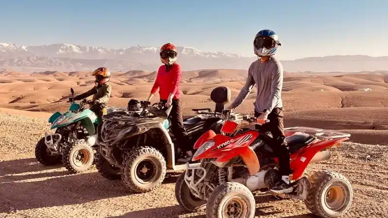 Four people riding four wheelers across the desert during a private tour in Morocco. 