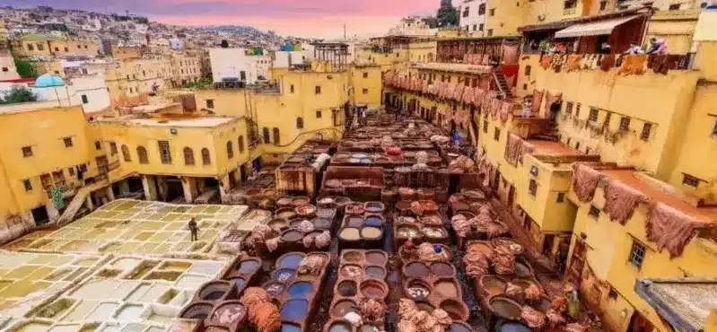 A bustling Marrakech street filled with people and their belongings, showcasing the vibrant culture of Morocco.
