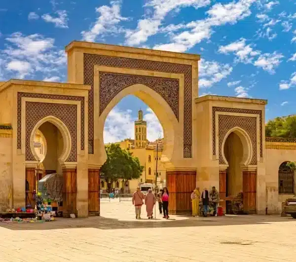 Entrance to Marrakech, Morocco, showcasing vibrant architecture and bustling atmosphere on the Volubilis Day Tour.