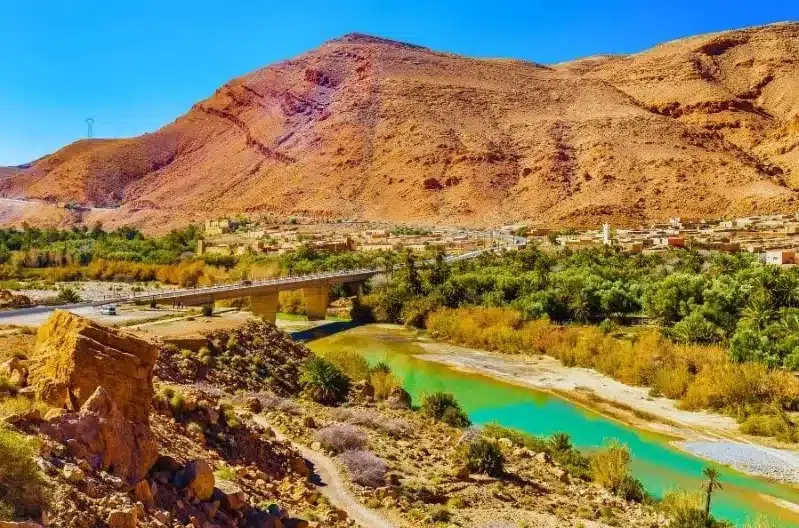  Scenic view of the Atlas Mountains in Morocco, showcasing rugged peaks during the Ziz Valley Desert Tour.