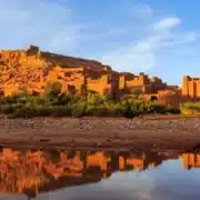 Ruins of a castle in the desert at sunset, showcasing the beauty of Custom Morocco Tours.