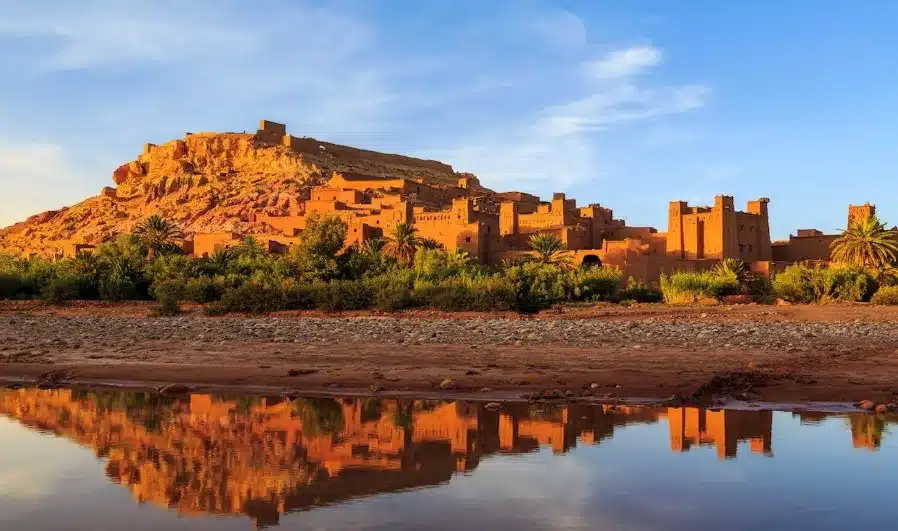 Ruins of a castle in the desert at sunset, showcasing the beauty of Custom Morocco Tours.