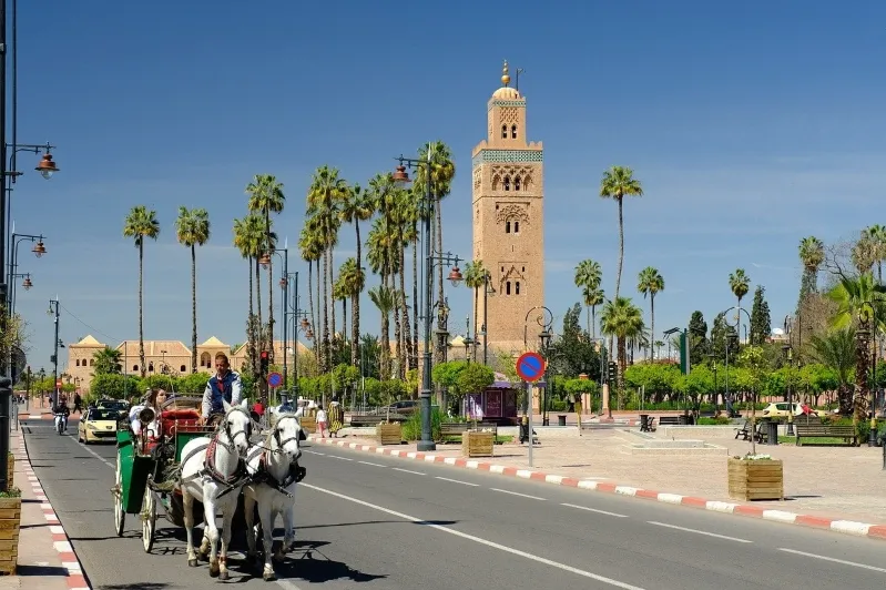 Entrance to Marrakech, Morocco, showcasing vibrant architecture and bustling atmosphere during a UK visitor's trip.