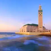 A coastal mosque in Casablanca, overlooking the ocean, showcasing stunning architecture and scenic views.