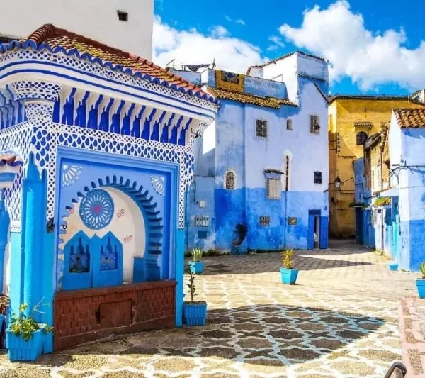 Scenic view of Chefchaouen, Morocco, showcasing its iconic blue buildings and mountainous backdrop during a visit.
