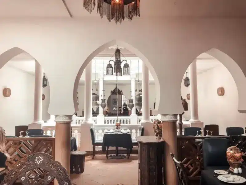 Elegant restaurant interior featuring arches and chandeliers, showcasing a sophisticated ambiance in Casablanca.
