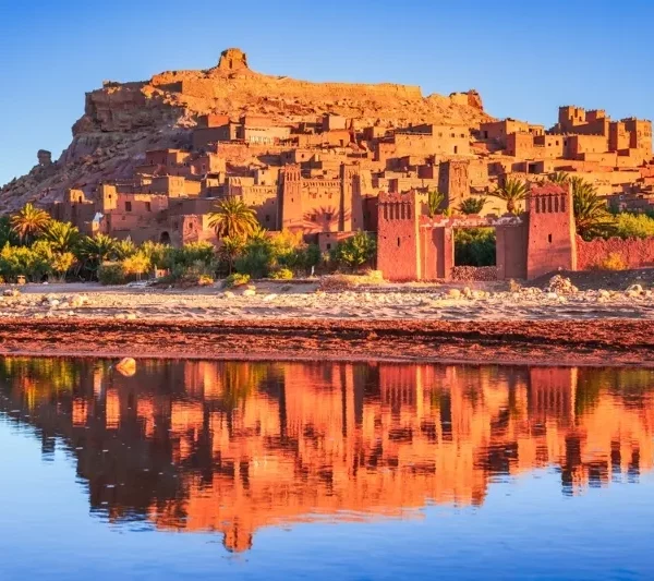 Reflection of a Moroccan city in water, showcasing the beauty of Ouarzazate to Marrakech via Desert and Ait Ben Haddou.