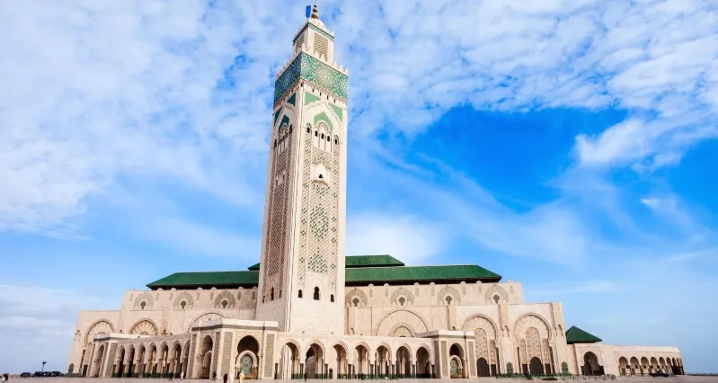 The Hassan II Mosque in Casablanca, Morocco, showcasing its stunning architecture against a clear blue sky.