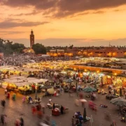 Sunset over Marrakech, showcasing vibrant colors illuminating the city's skyline and historic architecture.