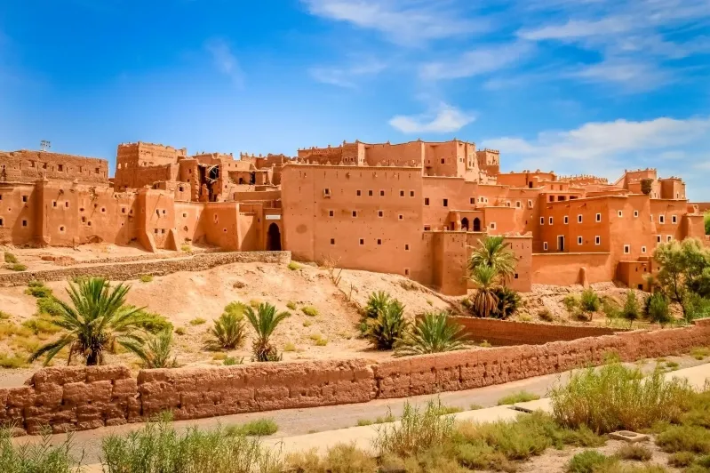 A panoramic view of the ancient city of Marrakesh, showcasing its historic architecture under clear blue skies.