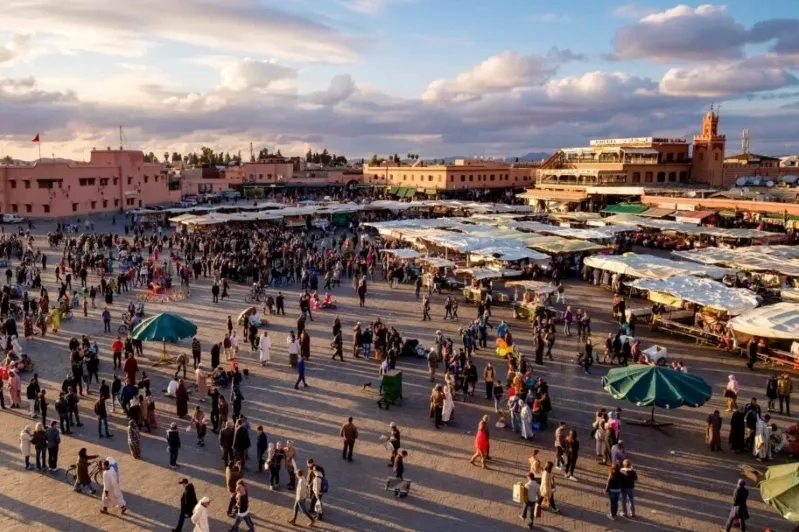 A panoramic view of Marrakech, Morocco, showcasing its vibrant architecture and bustling streets, promoting Morocco Holidays 2026.