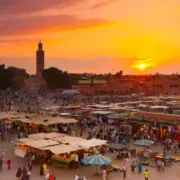Sunset over Marrakech, Morocco, showcasing vibrant colors in the sky, reflecting the warm weather of the region.