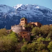Castle of Atlas in the Moroccan Atlas Mountains, showcasing rugged terrain and traditional architecture against a clear sky.