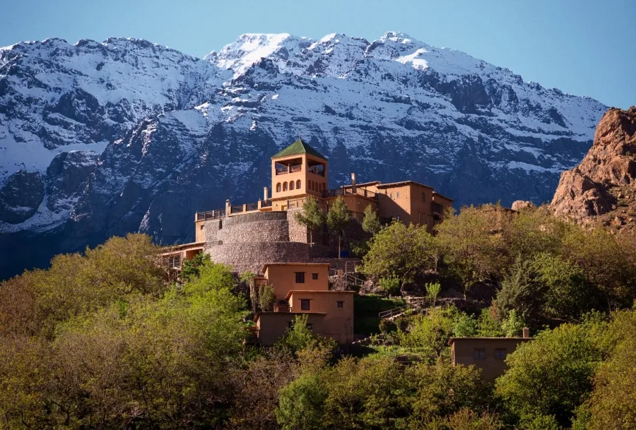 Castle of Atlas in the Moroccan Atlas Mountains, showcasing rugged terrain and traditional architecture against a clear sky.