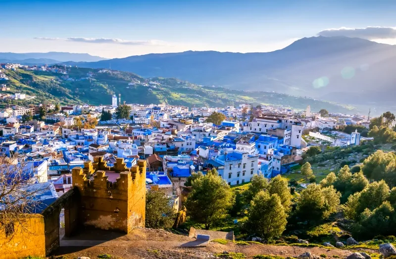 Scenic view of Chefchaouen, Morocco, showcasing its iconic blue buildings and mountainous backdrop during a trip marrakech.