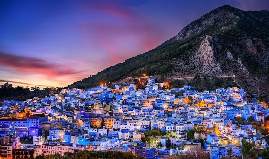Scenic view of Chefchaouen, Morocco, showcasing its iconic blue buildings and mountainous backdrop.
